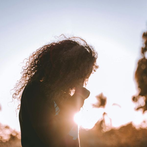Person meditating peacefully in a calm, minimalist environment.